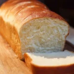 Freshly baked homemade bread loaf on a wooden table