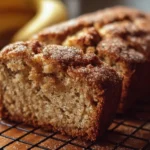 Slice of moist snickerdoodle banana bread topped with cinnamon sugar