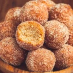 Cinnamon sugar baked donut holes in a bowl, perfect for snacking or dessert