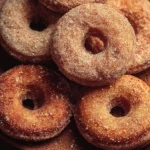 Freshly baked cinnamon sugar donuts on a plate