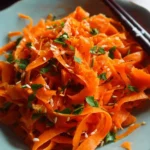 Easy carrot salad with Asian dressing prepared in a bowl
