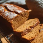 Homemade flourless sweet potato bread slices on a wooden cutting board