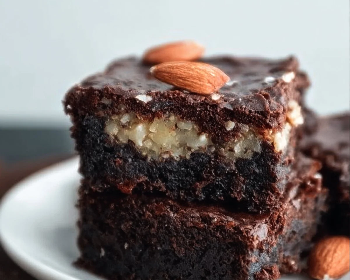 Keto Almond Joy Brownies topped with chocolate and coconut for a low-carb treat