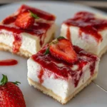 Delicious no bake strawberry cheesecake bars garnished with fresh strawberries