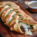 Philly Cheesesteak Crescent Braid with melted cheese and beef filling