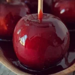 Delicious candy apples coated in caramel and toppings.