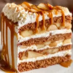 Layered caramel apple cake with apples and caramel drizzle on top
