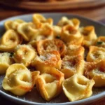 Cheesy baked tortellini bites served on a plate