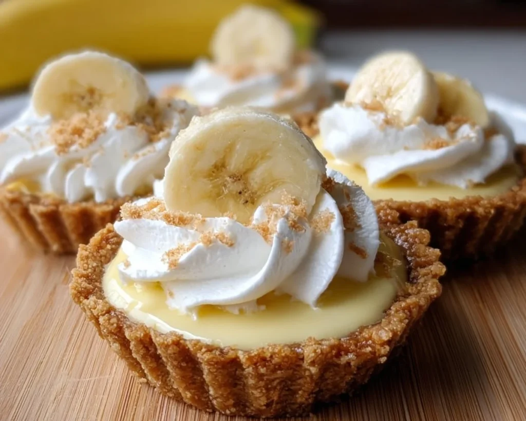 Mini banana cream pies with whipped cream and banana slices on top