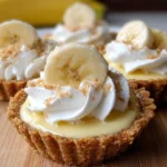 Mini banana cream pies with whipped cream and banana slices on top