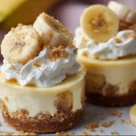 Delicious mini banana pudding cheesecakes topped with banana slices and whipped cream