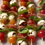 Mini Caprese Skewers with cherry tomatoes, basil, and mozzarella on a stick