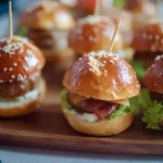Mini lye burgers topped with leberkäse garnished on a wooden platter