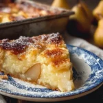 Delicious slice of pear custard pie topped with fresh pear slices and whipped cream