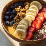 Colorful breakfast smoothie bowl topped with fresh fruits and nuts