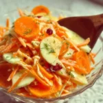Delicious carrot apple salad with fresh ingredients in a bowl
