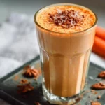 Delicious Carrot Cake Smoothie topped with spices and fresh carrots