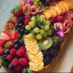 Delicious charcuterie and fruit board with assorted meats, cheeses, and fresh fruits