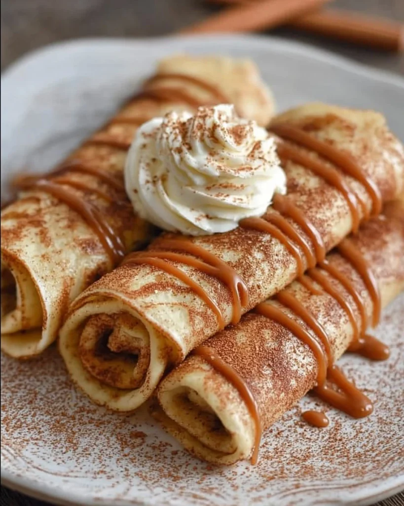 Delicious cinnamon roll protein crepes topped with creamy frosting