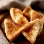 Cinnamon Sugar Toast Bows served on a plate with a sprinkle of cinnamon sugar.