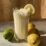 Creamy Brazilian lemonade in a glass with lime slices and mint garnish
