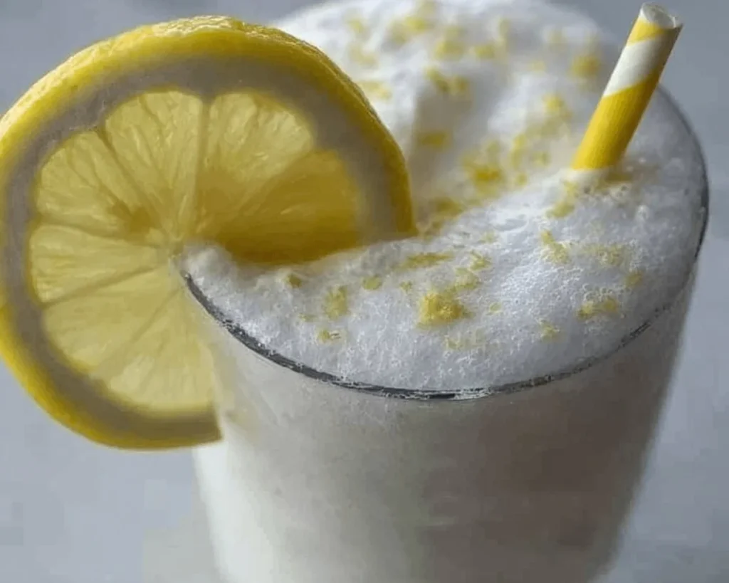 Refreshing frozen lemonade served in a glass with ice and lemon slices.