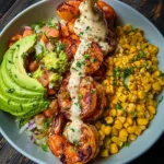 Delicious grilled shrimp bowl with avocado, corn salsa, and creamy sauce