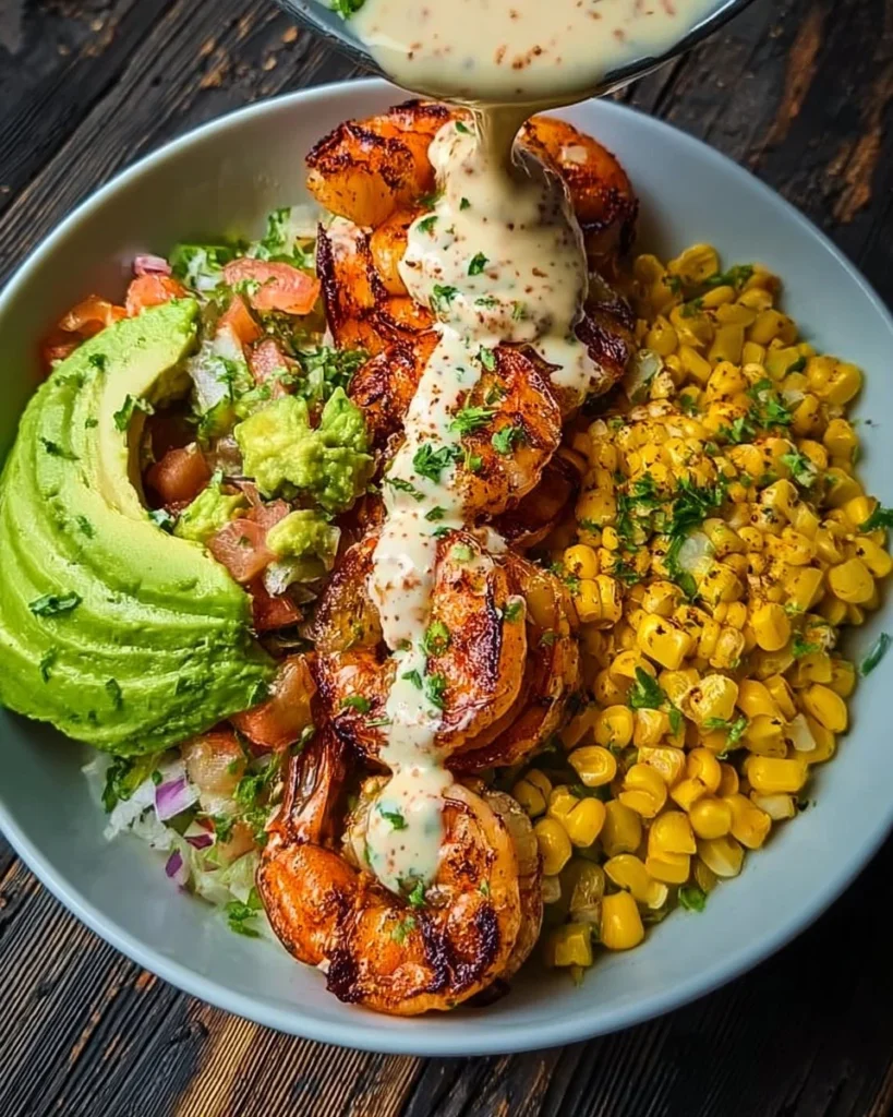 Delicious grilled shrimp bowl with avocado, corn salsa, and creamy sauce