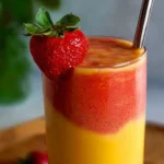 Healthy Mango Strawberry Sunrise Smoothie with fresh fruit and vibrant colors