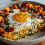 Delicious sweet potato breakfast bowl topped with fresh fruits and nuts