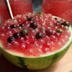 Colorful watermelon popping boba in a drink cup with ice.