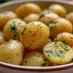 Delicious classic boiled potatoes served with herbs and butter.
