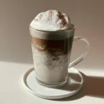 Black Sesame Hojicha Einspänner served in a glass with whipped cream