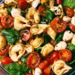 Delicious Caprese Tortellini Salad with fresh mozzarella, tomatoes, and basil