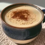 A delicious Kinako Hojicha Latte topped with frothy milk and kinako powder.