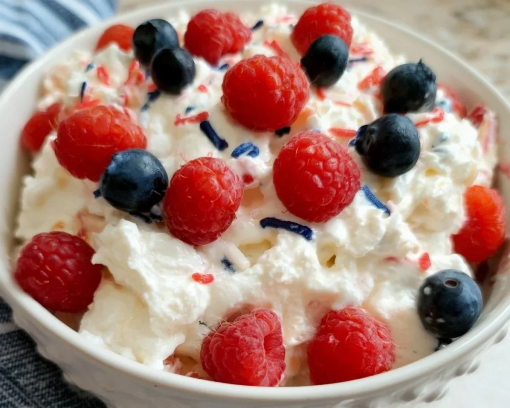 Red, White, and Blue Cheesecake Salad with strawberries, blueberries, and creamy cheesecake dressing