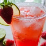 Strawberry Lime Mocktail Margarita in a glass with a slice of lime