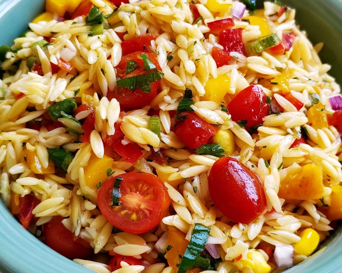 Delicious summer orzo pasta salad with fresh vegetables and herbs