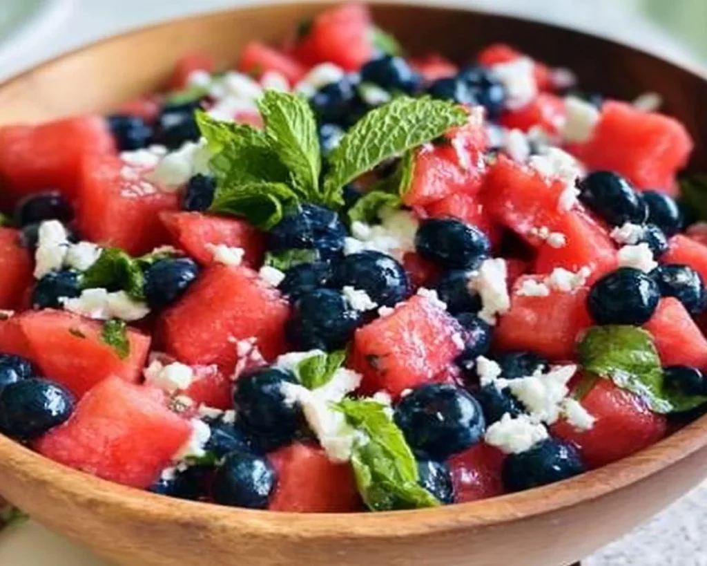 Vibrant Watermelon Blueberry Feta Salad with mint and lime dressing.