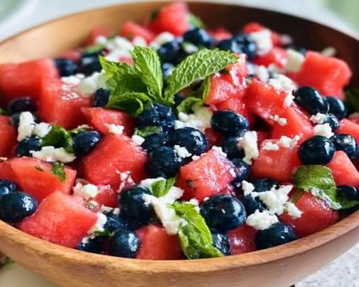 Vibrant Watermelon Blueberry Feta Salad with mint and lime dressing.