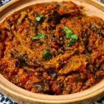 Zaalouk Moroccan Eggplant Salad served in a bowl with fresh herbs