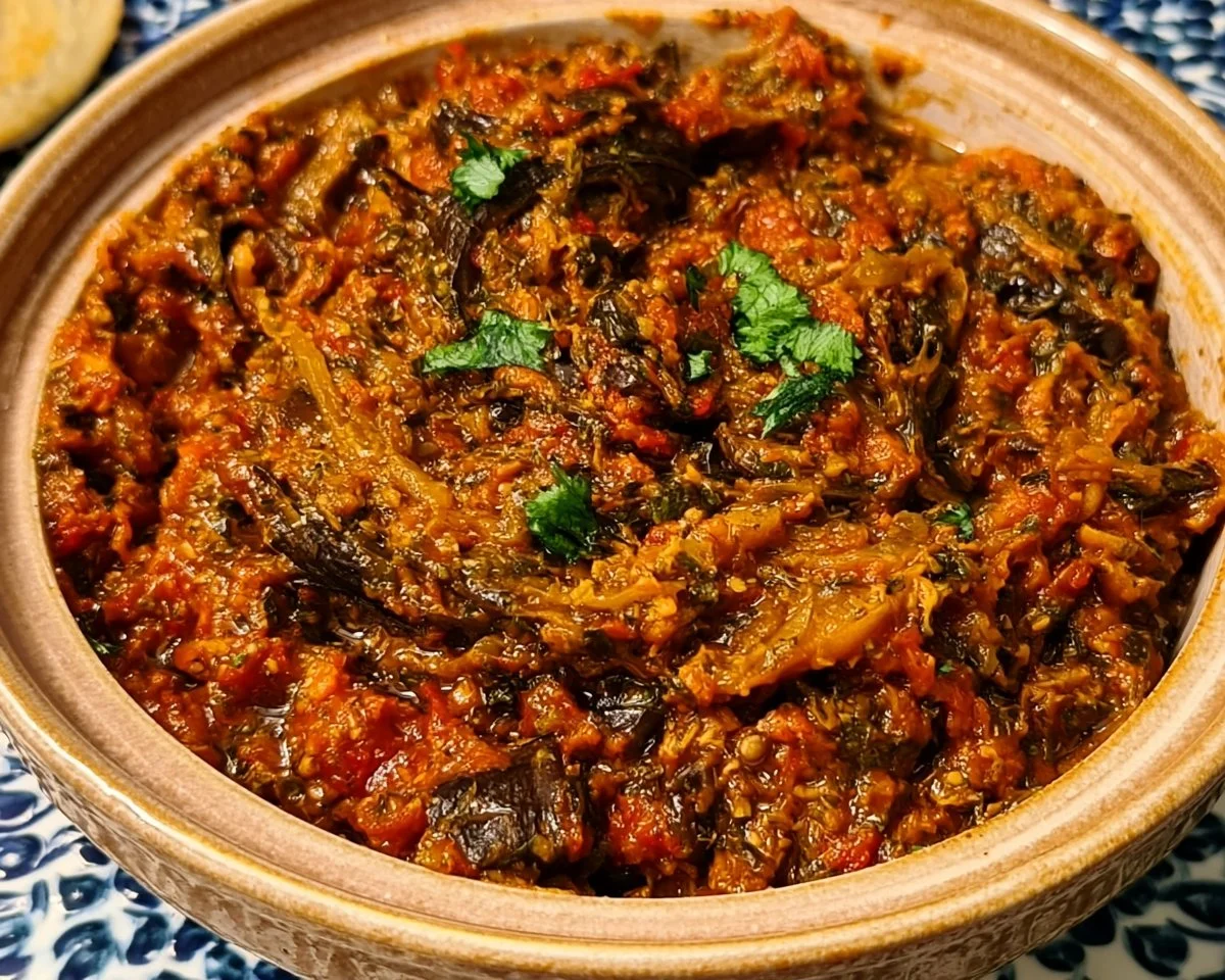 Zaalouk Moroccan Eggplant Salad served in a bowl with fresh herbs