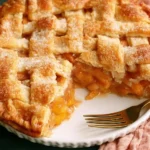 Deliciously baked peach pie with a golden crust and juicy peach filling