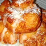 Fresh peach fritters with a golden-brown exterior and juicy peach filling