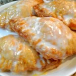 Delicious glazed peach hand pies with fresh peach filling and golden crust