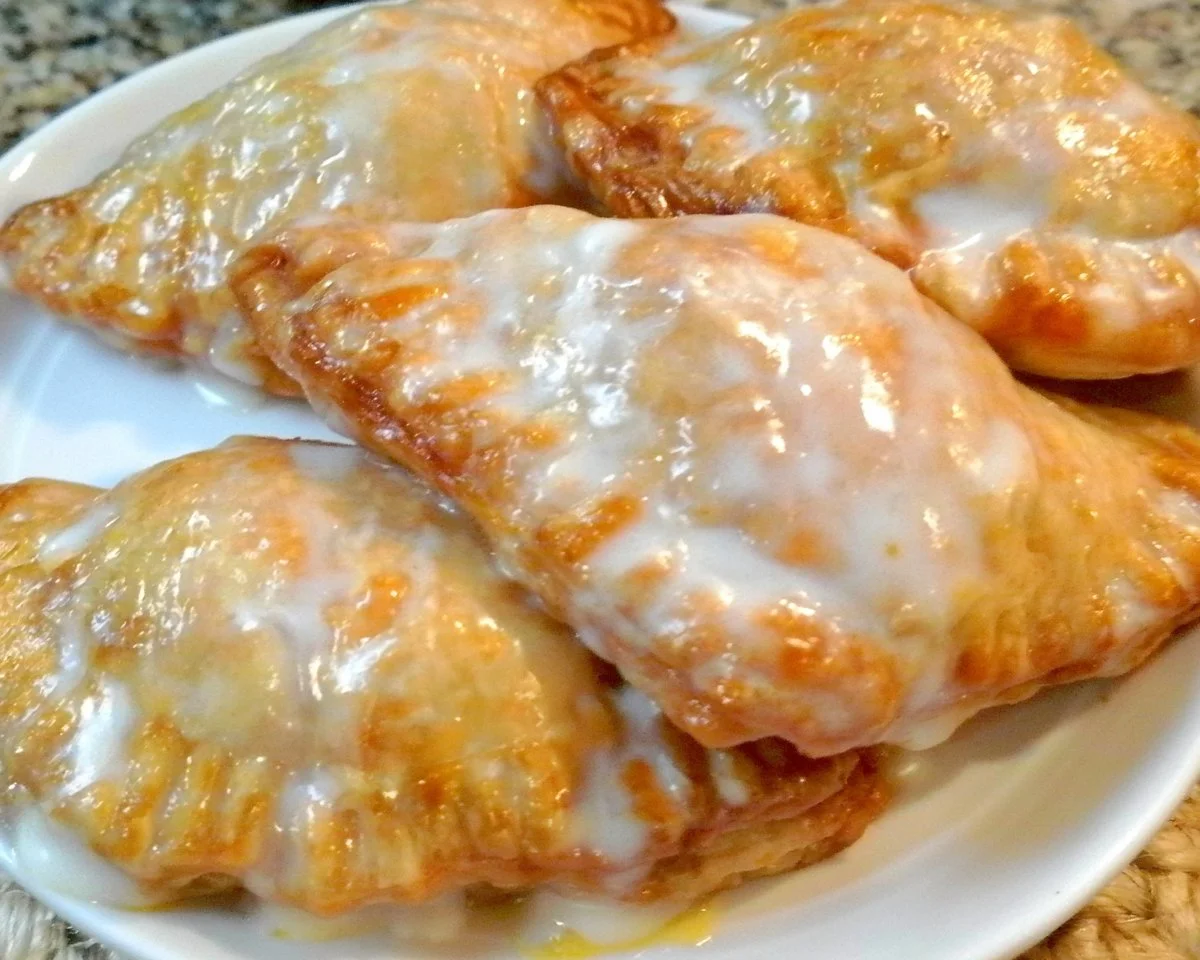 Delicious glazed peach hand pies with fresh peach filling and golden crust