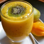 Refreshing Mango Kiwi Smoothie in a glass with vibrant colors.