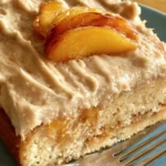 Delicious Peach Cake with Brown Sugar Frosting on a white plate