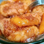 Delicious Peach Cobbler Dumplings served warm with a scoop of ice cream