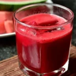 Refreshing watermelon beet juice served in a glass, showcasing its vibrant color.